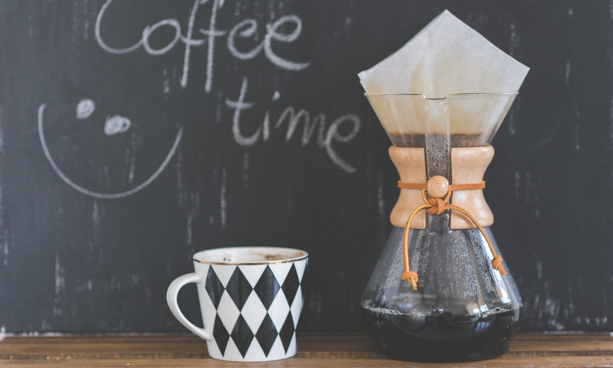 A coffee pot and cup on the table